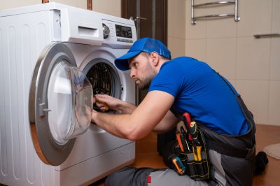 Technician Diagnosing a Commercial Washer